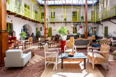 a patio with chairs and tables in a building at Niños Hotel Fierro in Cusco