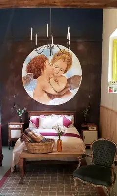 a bedroom with a painting of a woman holding a baby at Niños Hotel Fierro in Cusco