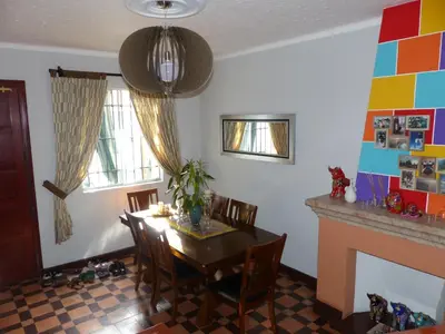 a dining room with a table and a fireplace at The Lighthouse Bed and Breakfast in Lima