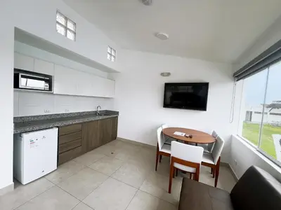a kitchen with a table and a tv on the wall at DM Hoteles Asia in Asia