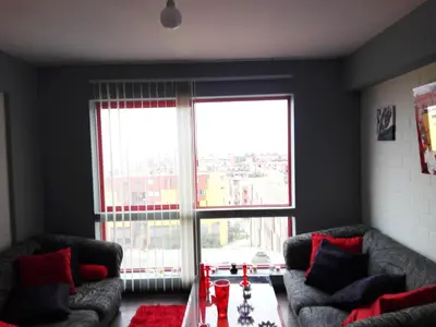 a living room with two couches and a large window at Cozy Room - Margot Arimborgo in Lima