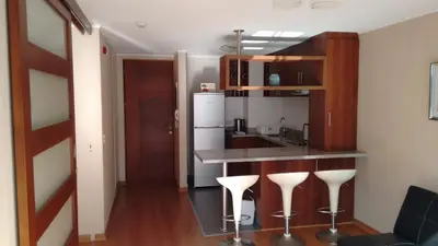 a kitchen with a counter and some bar stools at Ocean View Beautiful Aparment in Lima