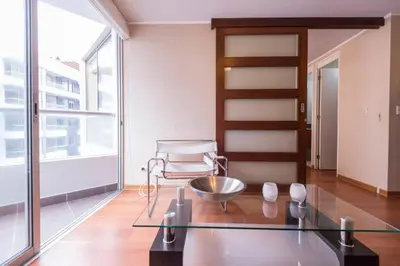 a room with a glass table and a chair at Ocean View Beautiful Aparment in Lima