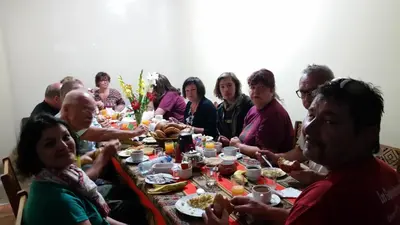 a group of people sitting at a table eating food at Hostal Vista Waynapata 123 in Machu Picchu