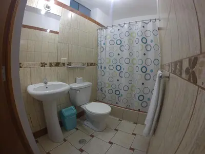 a bathroom with a sink and a toilet and a shower at Hospedaje el Telar in Nazca