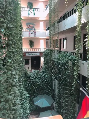 a building with a green wall with an umbrella at Hotel Boulevard in Lima