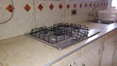 a stove top in a kitchen next to a sink at Bungalows Cerro Azul in Cerro Azul