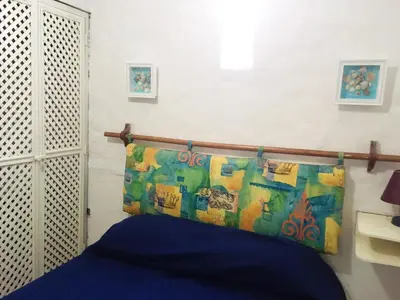 a bedroom with a bed with a head board at Bungalows Cerro Azul in Cerro Azul
