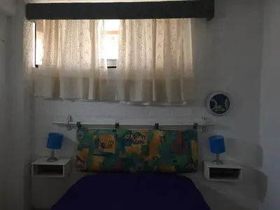 a bedroom with a bed and a window at Bungalows Cerro Azul in Cerro Azul