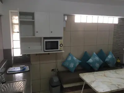 a small kitchen with a couch and a microwave at Bungalows Cerro Azul in Cerro Azul