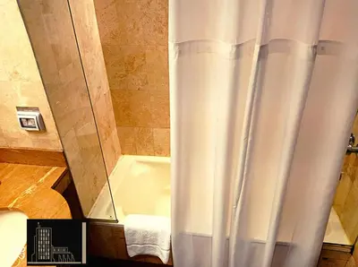 a shower in a bathroom with a shower curtain at J&A Classic Hotel in Lima