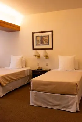 a hotel room with two beds and a picture on the wall at J&A Classic Hotel in Lima