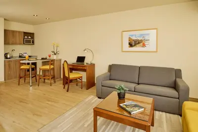a living room with a couch and a table at Estelar Apartamentos Bellavista in Lima