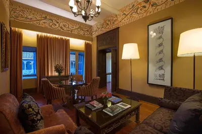 a living room with a couch and a table at Palacio del Inka, a Luxury Collection Hotel, Cusco in Cusco