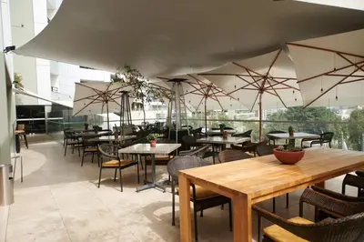 a restaurant with tables and chairs in a room at Casa Andina Premium Golf Los Incas in Lima