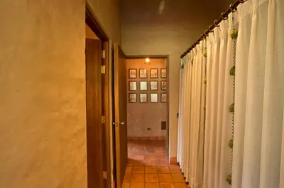 a hallway with white curtains and a hallway with a door at Luxury House & Unique Experience at Sacred Valley, Urubamba, Cusco in Urubamba