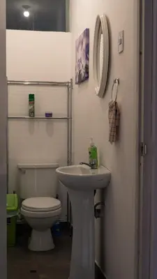 a white bathroom with a toilet and a sink at House in Cusco in Cusco