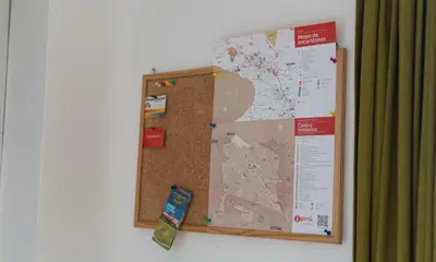 a corkboard hanging on a wall with a map at House in Cusco in Cusco
