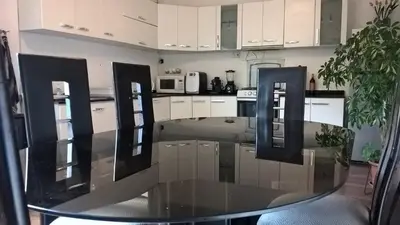 a kitchen with a glass table in the middle of it at House in Cusco in Cusco
