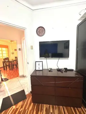 a living room with a flat screen tv on a wall at Departamento en San Isidro in Lima