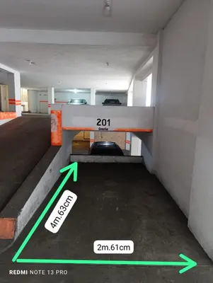 a room with green arrows on the floor and a room with an exit sign at MLA apartments - Bolognesi in Lima