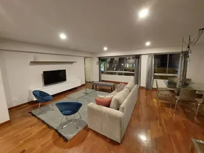 a living room with a couch and a table at MLA apartments - Bolognesi in Lima