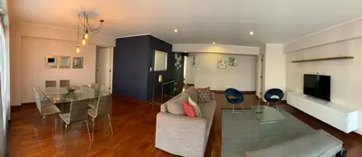 a living room and dining room with a glass table at MLA apartments - Bolognesi in Lima