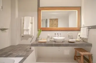 a bathroom with a sink and a mirror at Antigua Casona San Blas in Cusco