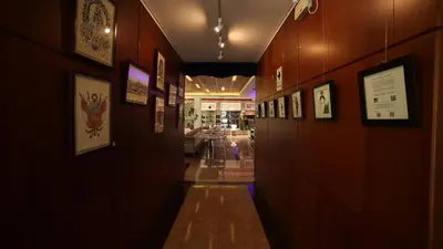 a hallway with pictures on the walls of a building at Lyz Business Hotel in Lima