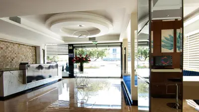 a lobby with a large television in a building at Lyz Business Hotel in Lima