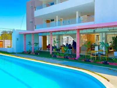 a house with a swimming pool next to a building at Hotel Balistra in Ica