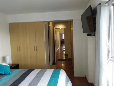 a bedroom with a bed and a flat screen tv at Elite Apartment 2 in Cusco