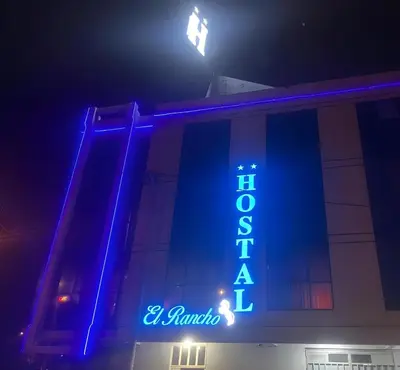 a blue sign on the side of a building at Hostal El Rancho in Huancayo