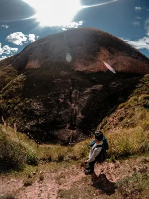 a person standing on a hill with a kite in the sky at Hostal Berlin in Jauja