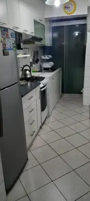 a kitchen with a refrigerator and a stove top oven at Departamento Jesus Maria in Lima