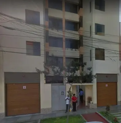 two people standing in front of a building at Departamento Jesus Maria in Lima