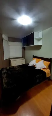a bedroom with a black bed with pillows on it at Departamento Jesus Maria in Lima