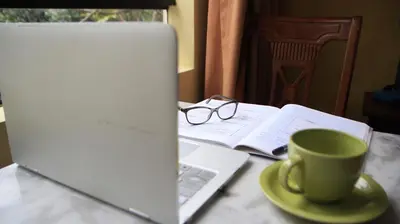 a laptop computer sitting on a table with a cup of coffee at Hotel El Farolito in Lima