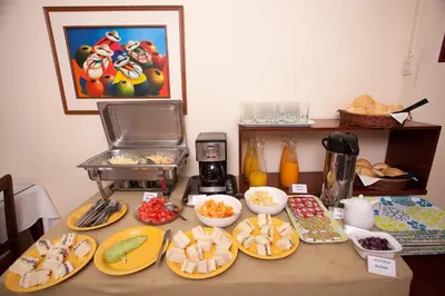 a table topped with plates of food and a mixer at Hotel El Farolito in Lima