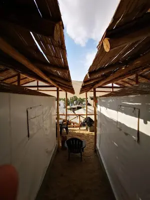 a pavilion with a table and a chair in it at Ecocamp Huacachina in Ica