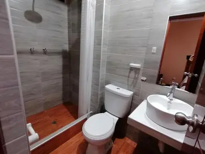 a bathroom with a toilet and a sink at Victtorios Hotel in Satipo