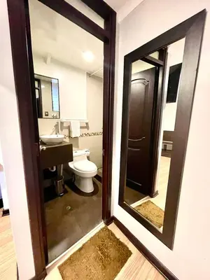 a bathroom with a mirror and a toilet and a sink at Tikala Cusco Boutique Hotel in Cusco
