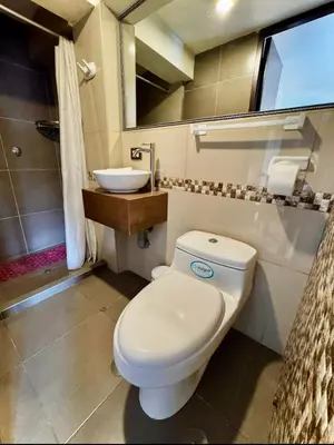 a bathroom with a white toilet and a sink at Tikala Cusco Boutique Hotel in Cusco