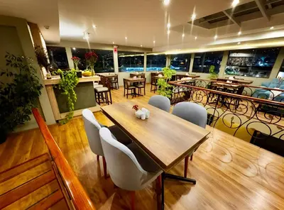 a dining room with a wooden table and chairs at Tikala Cusco Boutique Hotel in Cusco