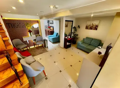a living room with a couch and a table at Tikala Cusco Boutique Hotel in Cusco