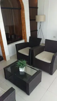 a living room with couches and a coffee table at CasaHotel Jockey Plaza Mall in Lima