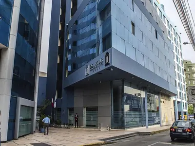 a large blue building on a city street at Del Pilar Miraflores Hotel in Lima
