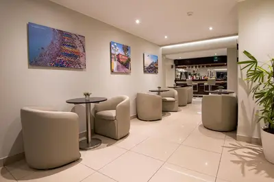 a waiting room with a row of chairs and tables at Mariel Hotel Boutique in Lima
