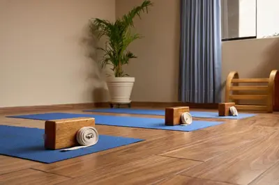a row of yoga mats on the floor with a potted plant at Hotel Park Suites in Lima