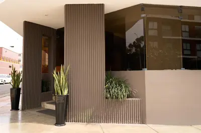 a building with potted plants on the side of it at Hotel Park Suites in Lima